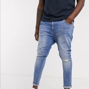 ASOS power stretch in mid wash blue with knee rips